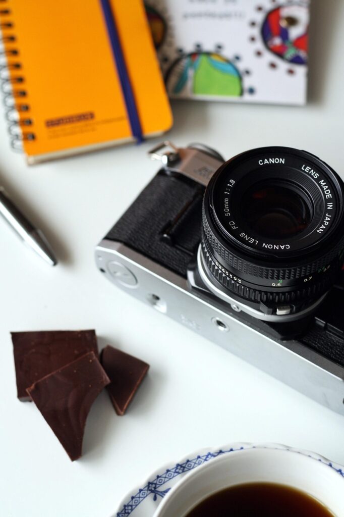 camera, canon, photography, office space, desk, lens, photographer, camera lens, digital, photo, photographic, professional, occupation, equipment, journalist, studio, office desk, pen, notepad, journalism, reporter, plan, inspiration, workplace, research, brainstorming, coffee, chocolate